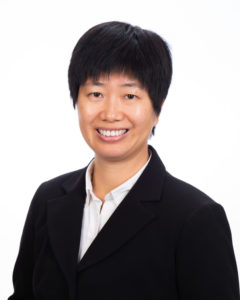Portrait of an asian woman with a short hair cut wearing a suit