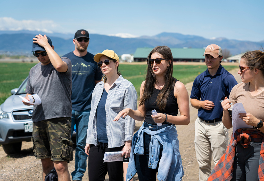 student asks question in field of Colorado farm