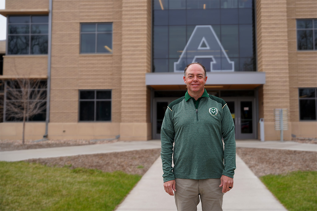 Man standing in front of Agricultural Sciences Building wearing CSU pullover