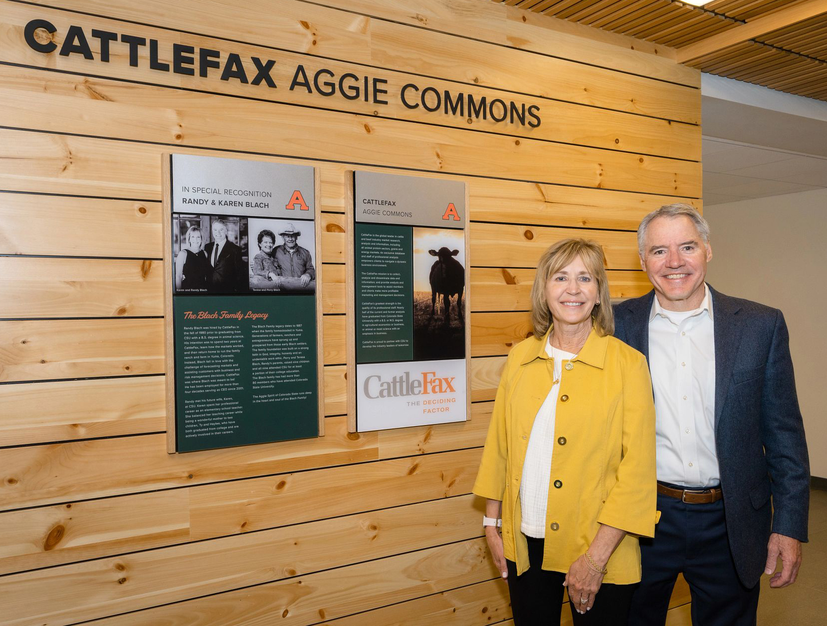 Randy and Karen standing in front of "Cattlefax Aggie Commons" sign in the new CSU Nutrien Ag Sciences building.