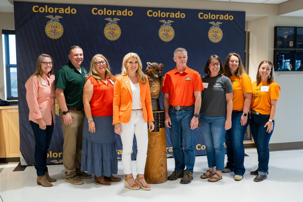 CSU President Amy Parsons poses with CAS Agricultural Education staff and faculty with the FFA Owl statue.
